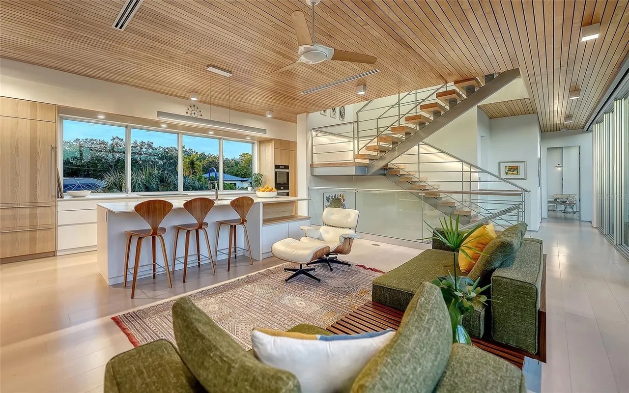 Open-plan kitchen and living with wood ceiling