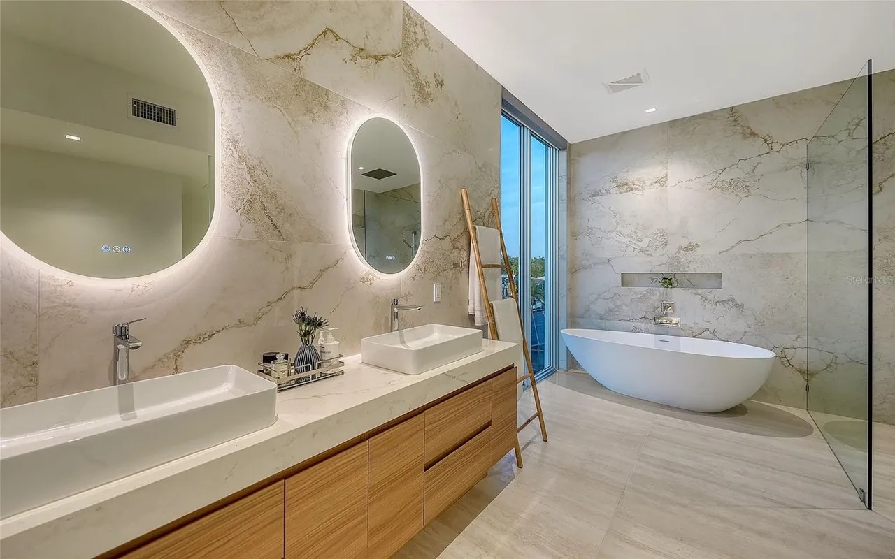 Spa-style master bathroom with marble finishes